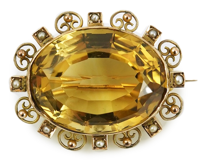 A late Victorian 9ct gold, citrine and seed pearl cluster set oval brooch